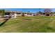 Aerial view of a complex of ranch-style homes with grassy areas at 9459 N 111Th Ave, Sun City, AZ 85351