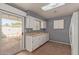 Kitchen with white cabinets and access to backyard at 9459 N 111Th Ave, Sun City, AZ 85351