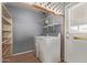 Laundry room with washer, dryer, shelving and exterior access at 9459 N 111Th Ave, Sun City, AZ 85351