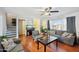 Spacious living room featuring hardwood floors, a large TV, and access to a staircase at 1307 N 44Th St, Phoenix, AZ 85008