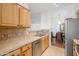 Clean kitchen with wood cabinets and tile countertops at 14950 W Mountain View Blvd # 6301, Surprise, AZ 85374