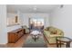 Bright living room with wood floors, patio access, and comfy seating at 14950 W Mountain View Blvd # 6301, Surprise, AZ 85374