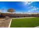 Landscaped backyard with artificial turf and a bench at 17765 W Silverwood Dr, Goodyear, AZ 85338