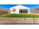 Landscaped backyard with artificial turf and a sunroom at 17765 W Silverwood Dr, Goodyear, AZ 85338