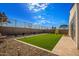 Artificial turf backyard with stone pathway and fence at 17765 W Silverwood Dr, Goodyear, AZ 85338