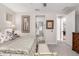Well-lit bedroom with ensuite bathroom access and a view of the hallway at 17765 W Silverwood Dr, Goodyear, AZ 85338