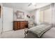 Bedroom with large dresser, comfortable chair, and soft bedding at 17765 W Silverwood Dr, Goodyear, AZ 85338