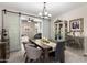 Spacious dining area with a farmhouse table and access to an adjacent room at 17765 W Silverwood Dr, Goodyear, AZ 85338