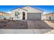 Single-story home with gray garage door and desert landscaping at 17765 W Silverwood Dr, Goodyear, AZ 85338