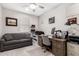 Home office with desk, computer, and comfortable couch at 17765 W Silverwood Dr, Goodyear, AZ 85338