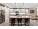 Bright kitchen featuring white cabinets, center island, and breakfast bar at 17765 W Silverwood Dr, Goodyear, AZ 85338