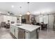 Open concept kitchen with island, white cabinets, and stainless steel appliances at 17765 W Silverwood Dr, Goodyear, AZ 85338