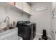 Bright laundry room with washer, dryer, and built-in cabinets at 17765 W Silverwood Dr, Goodyear, AZ 85338