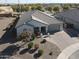 Single-story home with gray exterior, paver driveway, and nicely landscaped yard at 18769 N Falcon Ln, Maricopa, AZ 85138