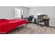 Cozy bedroom with a red bedspread and a workspace at 1920 W Lindner Ave # 130, Mesa, AZ 85202