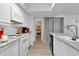 Bright kitchen featuring white cabinets, granite countertops, and ample storage at 1920 W Lindner Ave # 130, Mesa, AZ 85202