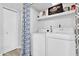 Laundry room with washer, dryer, and storage shelves at 1920 W Lindner Ave # 130, Mesa, AZ 85202