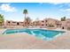 Community pool with surrounding lounge chairs at 1920 W Lindner Ave # 130, Mesa, AZ 85202