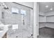 Modern bathroom with walk-in shower, marble tile, and built-in bench at 19436 S 208Th Pl, Queen Creek, AZ 85142