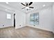 Bright bedroom with wood-look floors and a ceiling fan at 19436 S 208Th Pl, Queen Creek, AZ 85142