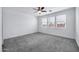 Spacious bedroom featuring three windows and a ceiling fan at 19436 S 208Th Pl, Queen Creek, AZ 85142