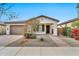 Single-story home with a two-car garage and landscaped front yard at 19436 S 208Th Pl, Queen Creek, AZ 85142