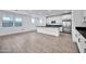 Modern kitchen with white cabinets, a large island, and stainless steel appliances at 19436 S 208Th Pl, Queen Creek, AZ 85142