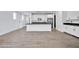 Modern kitchen features white cabinets, a large island, and stainless steel appliances at 19436 S 208Th Pl, Queen Creek, AZ 85142