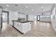 Modern kitchen with a large island, white cabinets, and open layout at 19436 S 208Th Pl, Queen Creek, AZ 85142