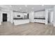 Spacious kitchen boasts white cabinets, an island with seating, and stainless steel appliances at 19436 S 208Th Pl, Queen Creek, AZ 85142