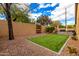 Artificial turf backyard with a seating area and built-in grill at 20472 N 90Th Ln, Peoria, AZ 85382