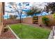 Artificial turf backyard with decorative rock border and potted plants at 20472 N 90Th Ln, Peoria, AZ 85382