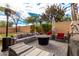 Relaxing backyard patio with seating area, fire pit, and artificial turf at 20472 N 90Th Ln, Peoria, AZ 85382