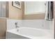 Oval soaking tub with window and towel at 20472 N 90Th Ln, Peoria, AZ 85382