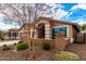 House exterior with drought-tolerant landscaping and a tree at 20472 N 90Th Ln, Peoria, AZ 85382