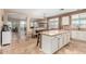 Open kitchen with island, granite counters, and stainless steel appliances at 20472 N 90Th Ln, Peoria, AZ 85382
