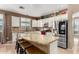Kitchen boasts granite countertops and white cabinets at 20472 N 90Th Ln, Peoria, AZ 85382