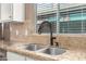 Kitchen sink with granite countertop and modern faucet at 20472 N 90Th Ln, Peoria, AZ 85382