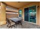 Covered patio with seating area and access to backyard at 20472 N 90Th Ln, Peoria, AZ 85382