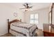 Cozy bedroom with a queen bed, wood dresser, and ceiling fan at 2101 S Meridian Rd # 268, Apache Junction, AZ 85120