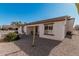 Back exterior view showing a covered patio and desert landscaping at 2101 S Meridian Rd # 268, Apache Junction, AZ 85120