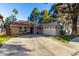 Attractive curb appeal with a two-car garage and mature trees at 230 E Tremaine Ave, Gilbert, AZ 85234