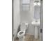 Clean bathroom with pedestal sink and updated fixtures at 26520 N 132Nd Ln, Peoria, AZ 85383