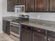 Modern kitchen with stainless steel appliances and granite countertops at 26520 N 132Nd Ln, Peoria, AZ 85383