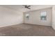 Bright bedroom with neutral carpeting and ceiling fan at 3641 N 309Th Dr, Buckeye, AZ 85396