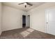 Bright bedroom with carpeted floor, ceiling fan and spacious closet at 3641 N 309Th Dr, Buckeye, AZ 85396