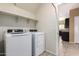 Bright laundry room with washer, dryer, and shelving at 3641 N 309Th Dr, Buckeye, AZ 85396