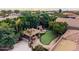 Outdoor kitchen, fireplace, and putting green at 3731 E Halifax Cir, Mesa, AZ 85205