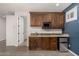 Basement kitchenette with dark wood cabinets and granite countertop at 3731 E Halifax Cir, Mesa, AZ 85205