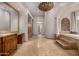Luxurious bathroom with soaking tub, granite vanity, and ample storage at 3731 E Halifax Cir, Mesa, AZ 85205